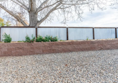 Fence with metal sheeting and raised flower bed Grand Valley Repair in Grand Junction